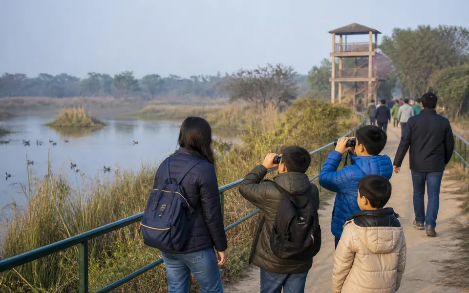 Family using binoculars beside the lake at Nawabganj Bird Sanctuary near Lucknow.