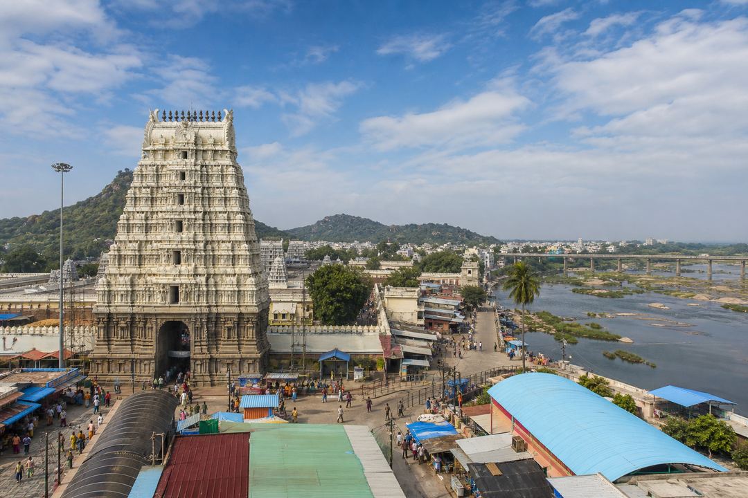 Wide view of Srikalahasteeswara Temple gopuram and the nearby Swarnamukhi riverfront in Srikalahasti town.