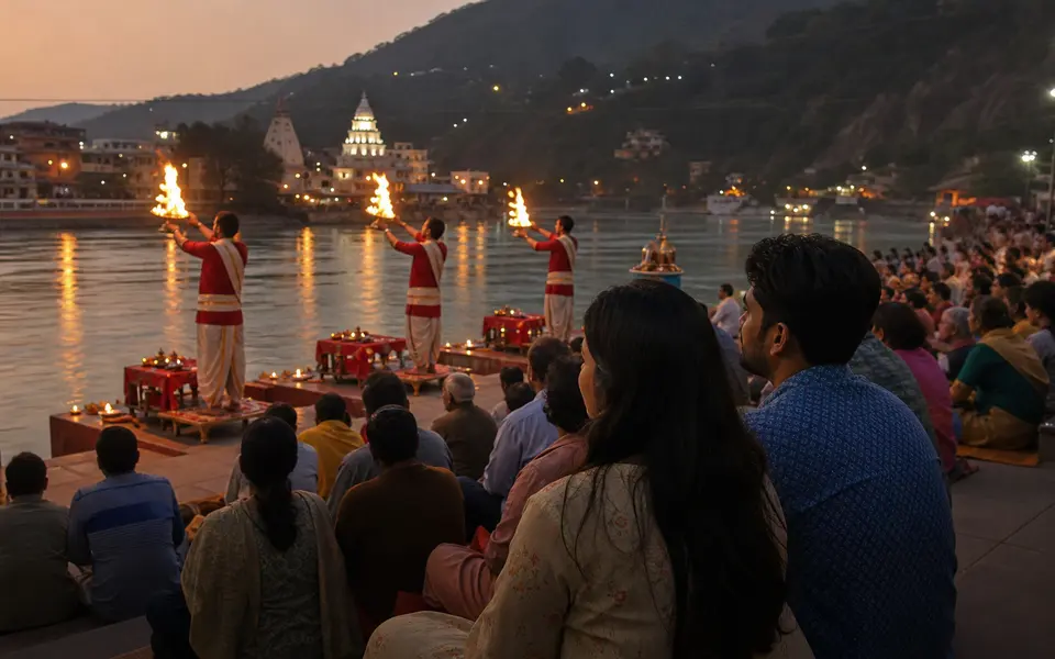 Evening Ganga Aarti at a ghat in Rishikesh with priests holding lamps, devotees seated on the steps and a couple watching quietly near the river.