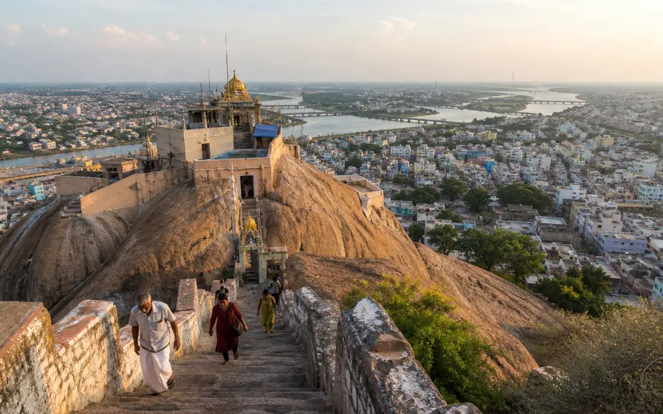 Rock Fort temple complex rising above Tiruchirappalli with long stone steps and the city spreading out below.