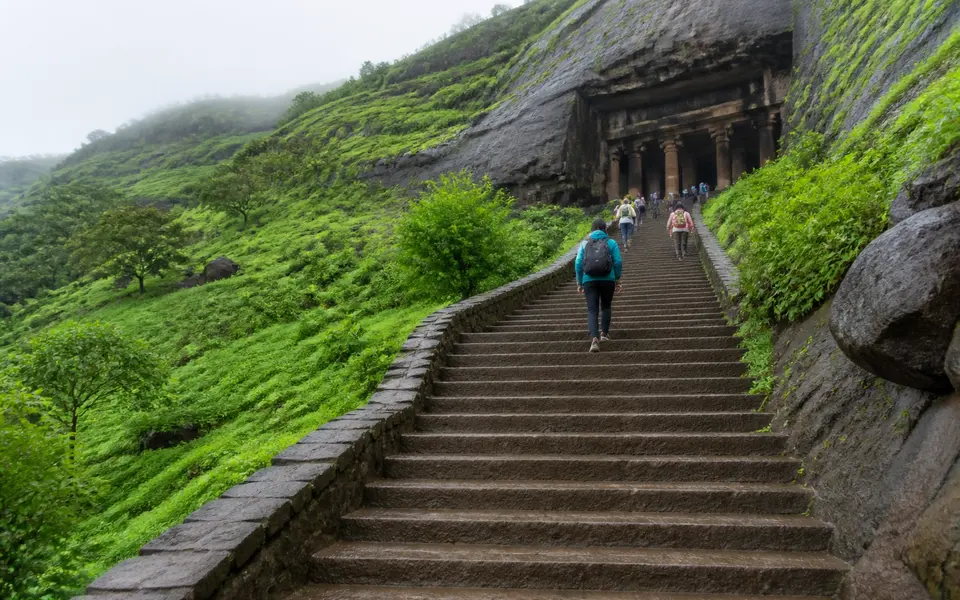 Stone steps leading up to rock-cut Buddhist caves on a hillside near Lonavala.