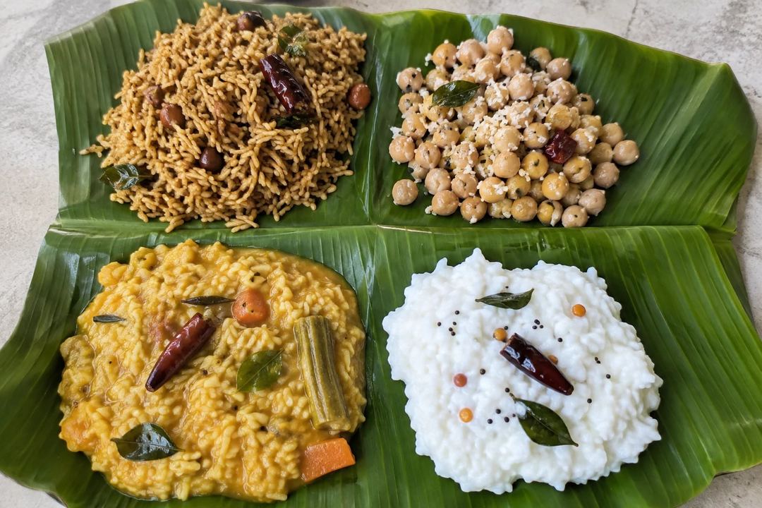 Puliyodarai chickpea sundal sambar rice and curd rice served on banana leaf sections