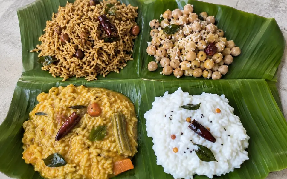 Puliyodarai chickpea sundal sambar rice and curd rice served on banana leaf sections