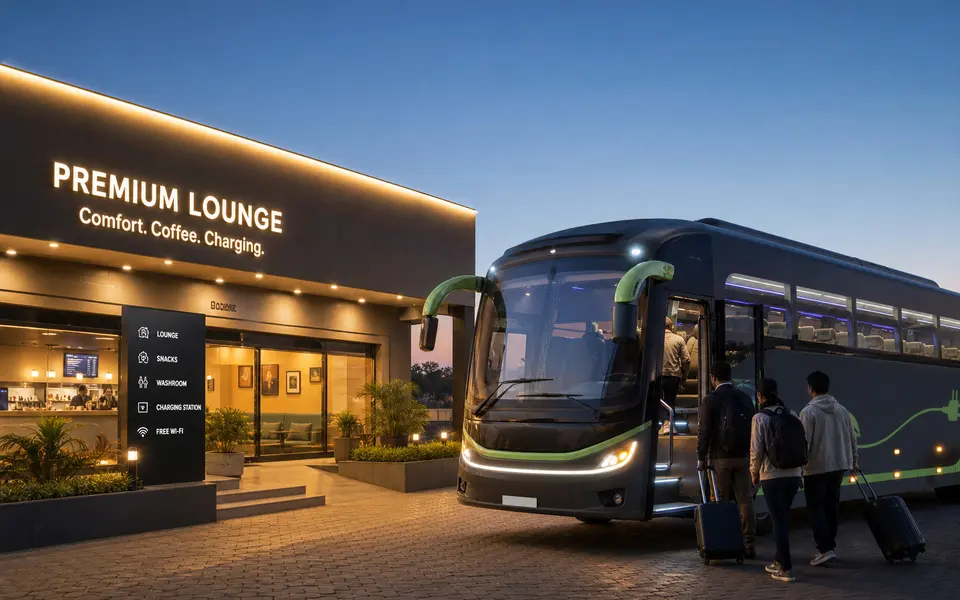 Modern electric intercity coach at a clean bus lounge with a few passengers boarding in the evening.