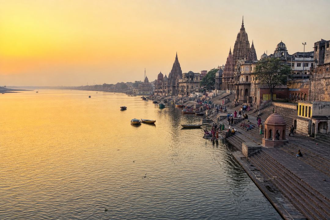 Yamuna riverfront in Mathura at sunrise with temple spires and ghats along the bank.