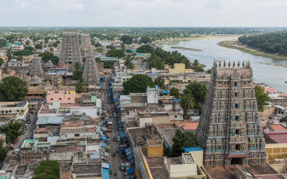 View of Kumbakonam town with multiple temple gopurams rising above streets near the rivers.