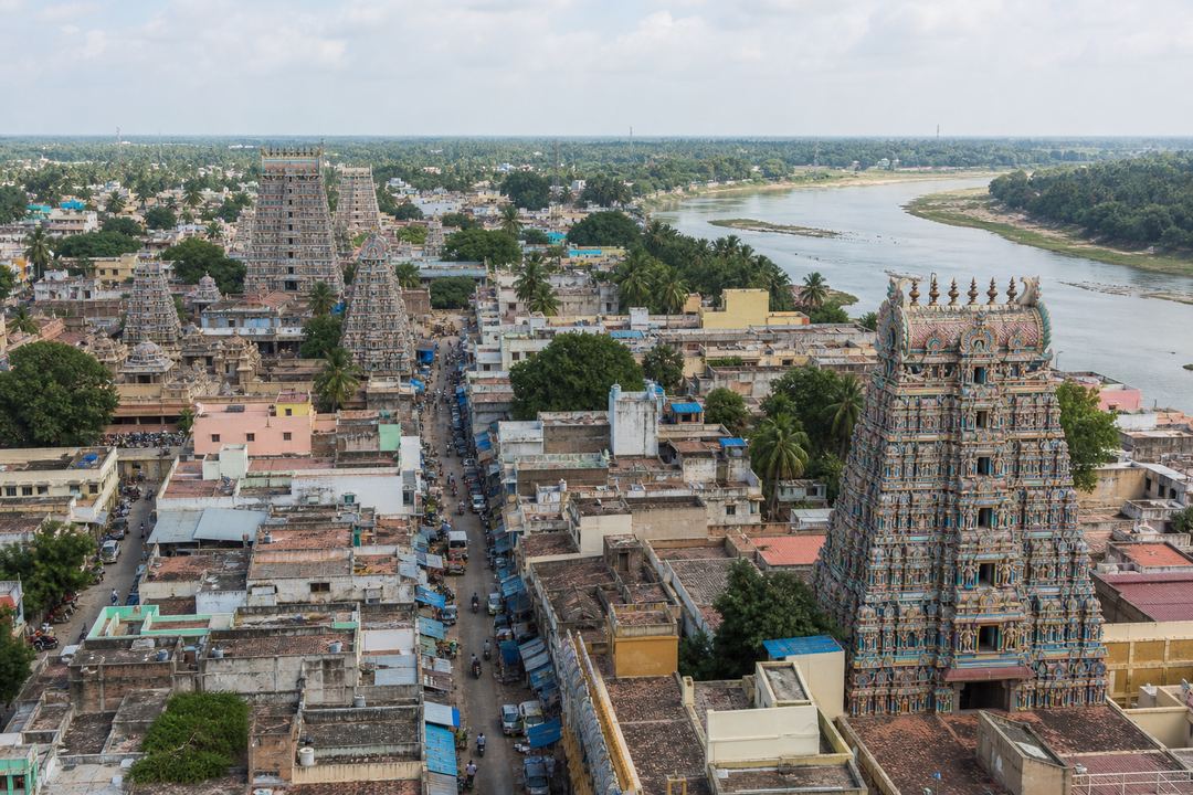 View of Kumbakonam town with multiple temple gopurams rising above streets near the rivers.