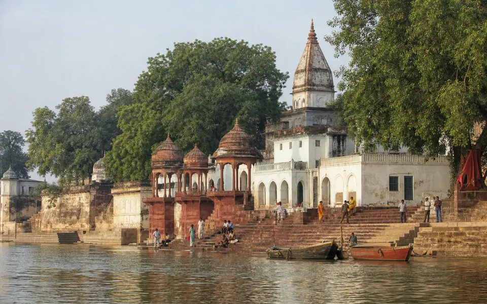 Illustrative view of Bithoor's Ganga riverfront ghats with temple pavilions and boats.