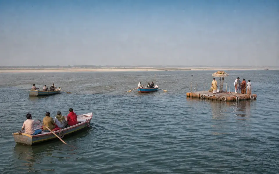 Illustrative view of passenger boats and a ritual platform at Triveni Sangam in Prayagraj.