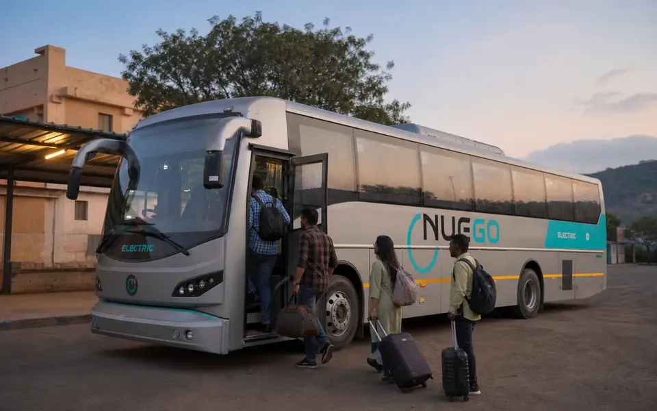 Passengers boarding a NueGo electric intercity coach for a served longer-distance corridor before connecting to Srikalahasti.