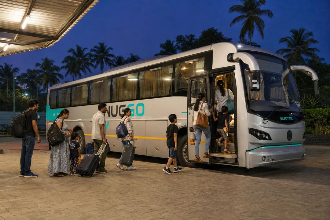 Travellers boarding a clearly branded NueGo electric intercity coach at an Indian terminal at night.