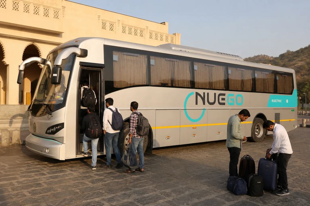Travellers boarding a clearly branded NueGo electric intercity coach for a Rajasthan journey.