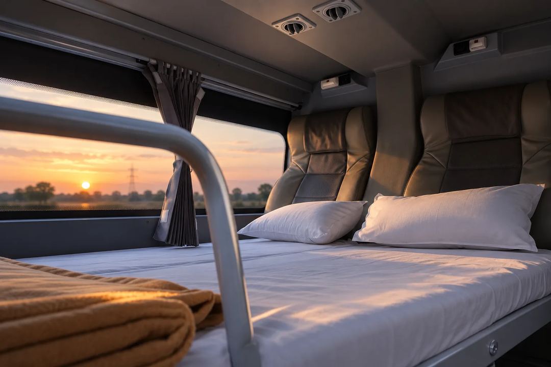 Illustration of a sleeper berth with pillows and a window view at sunset.